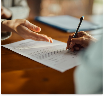 Close up of unrecognizable black woman signing a contract during a meeting with her agent in the office. Copy space.