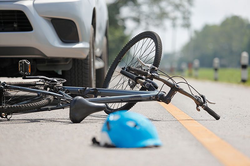 bike and helmet on the road next to a bike signifying a crash