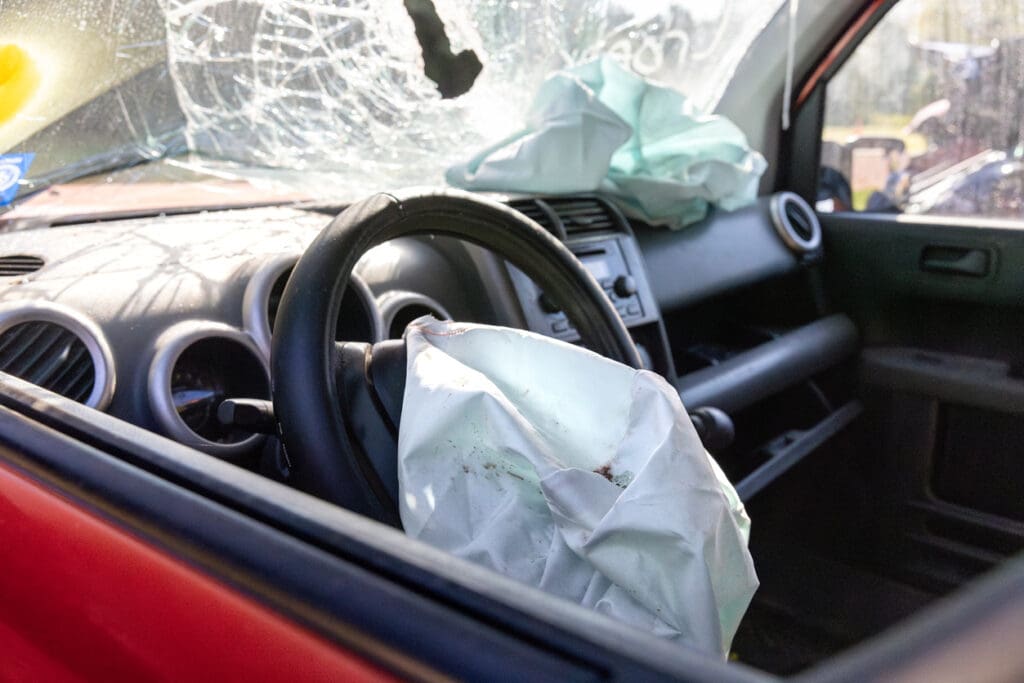 A deployed air bag and broken windshiled